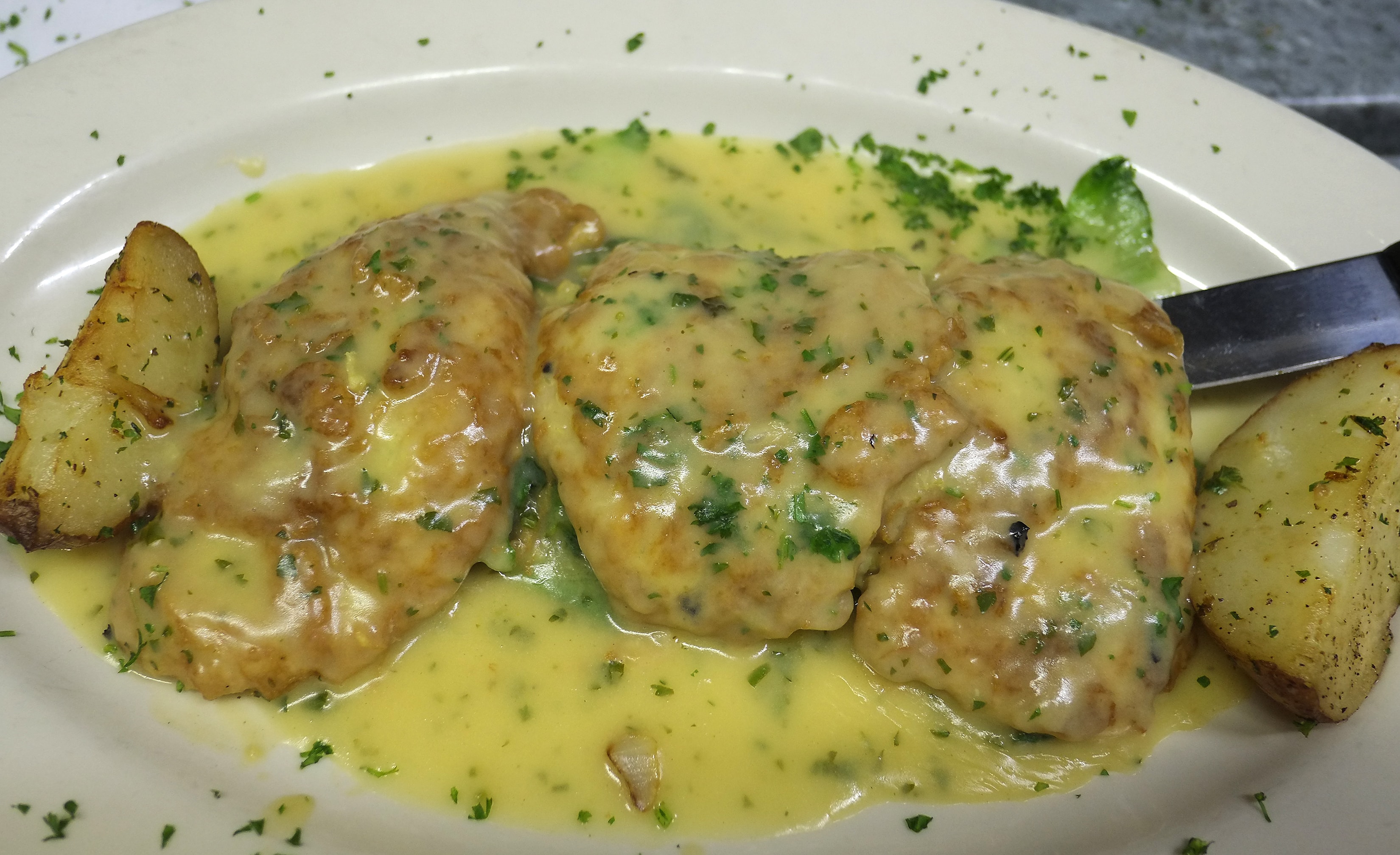 Chicken Francese with roasted potatoes in lemon butter sauce