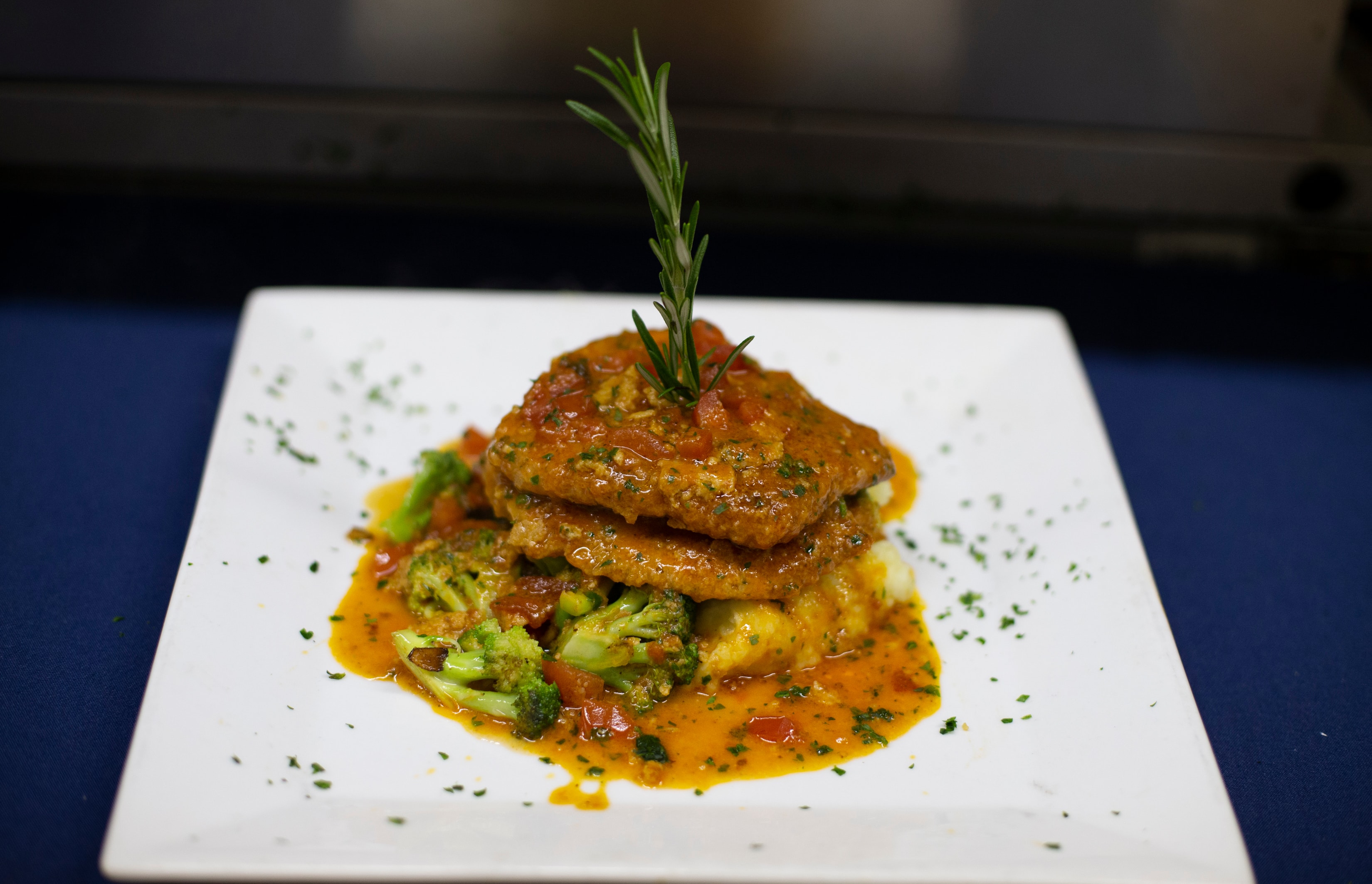 Herb-crusted fish with broccoli and tomato sauce