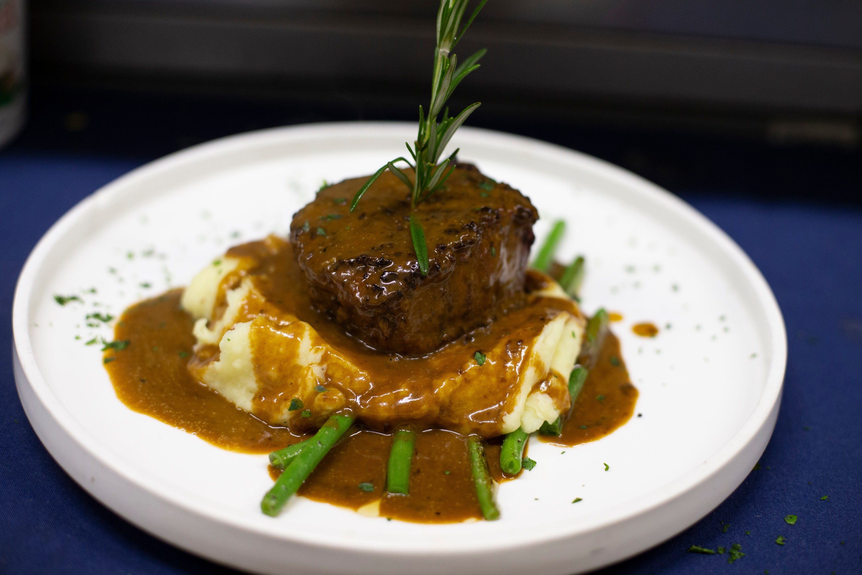 Filet mignon with demi-glace sauce, mashed potatoes and green beans