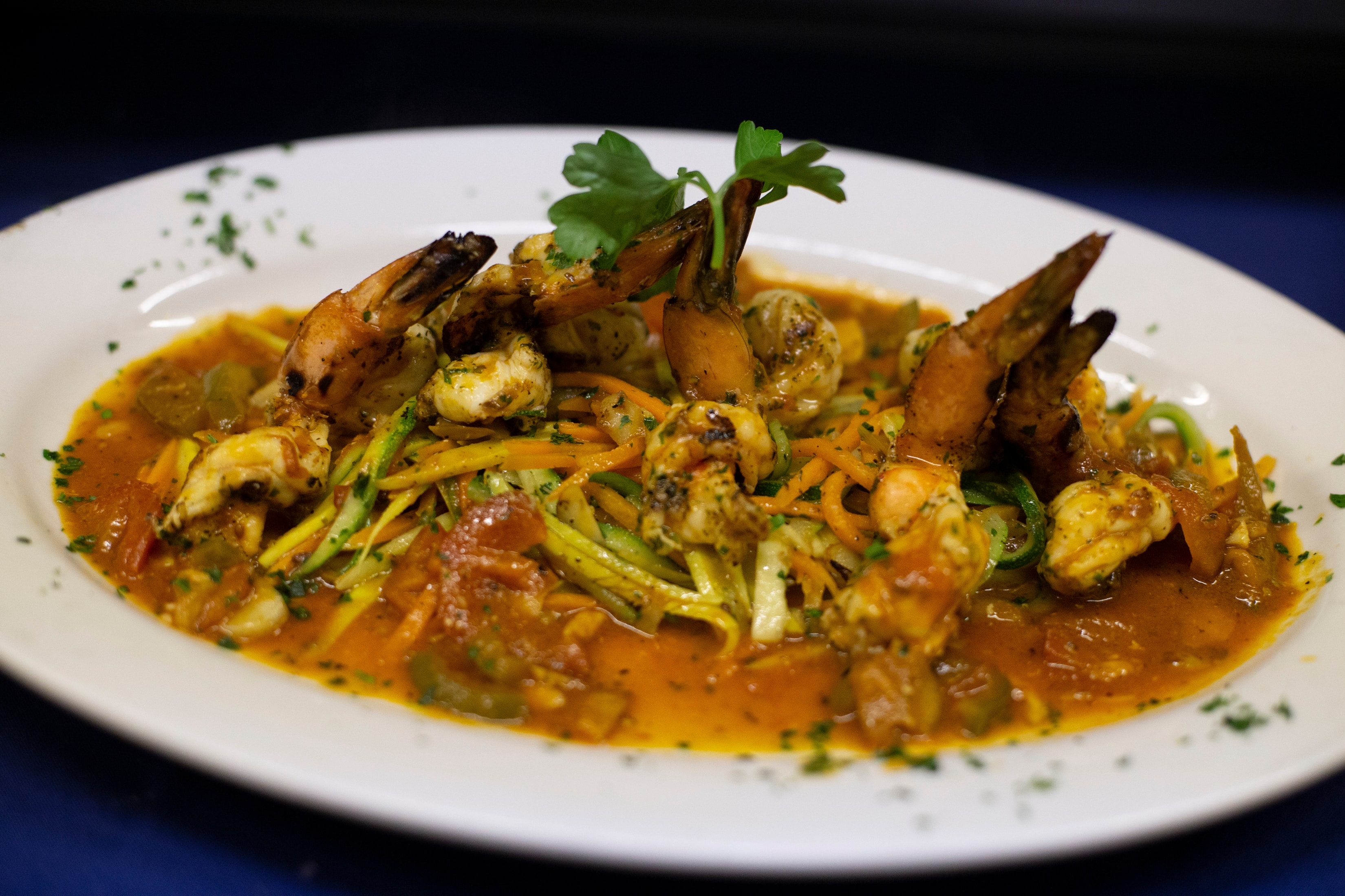 Shrimp and mussels with zucchini in tomato sauce