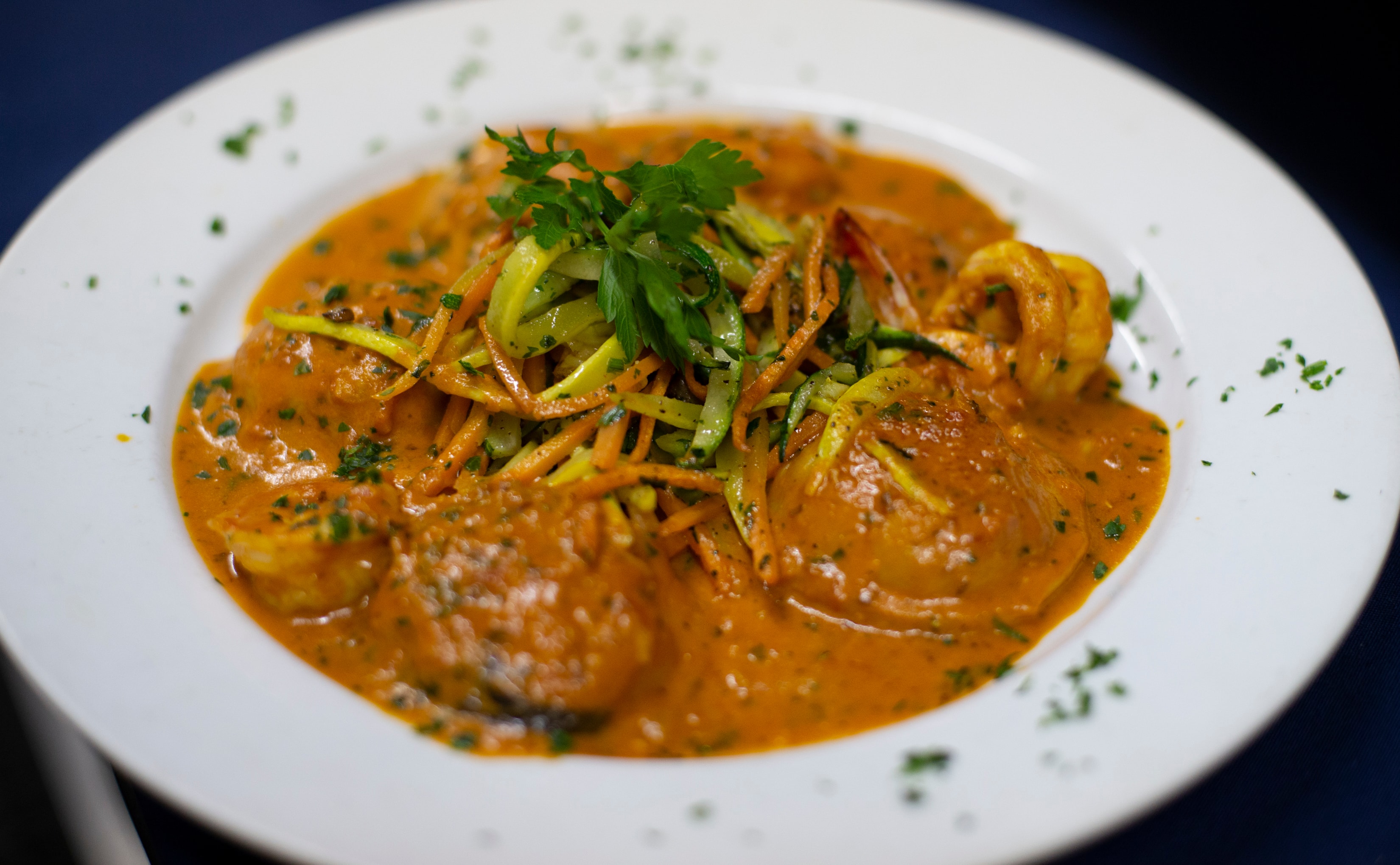 Jumbo shrimp with zucchini noodles in tomato bisque sauce