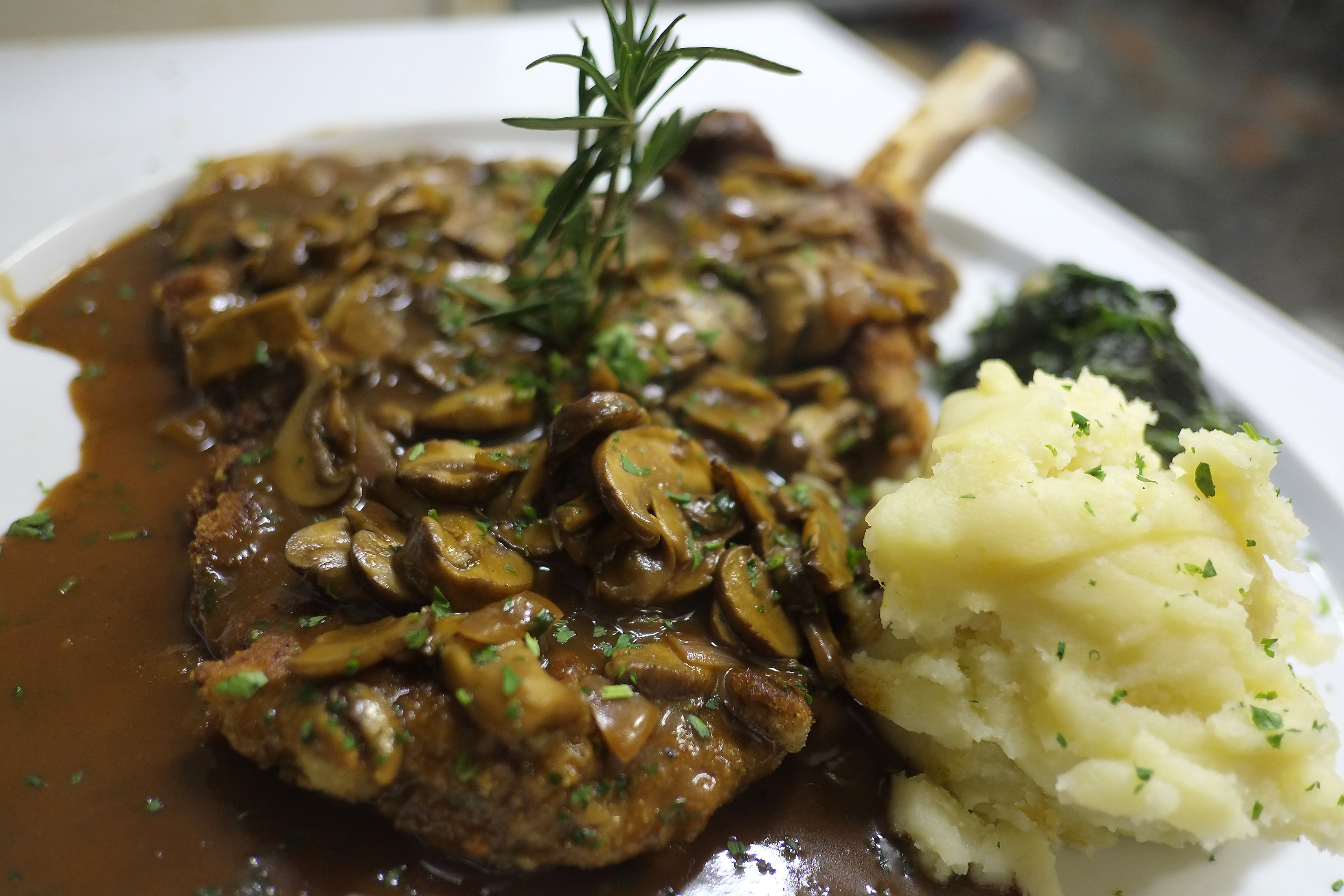 Veal chop with mushroom sauce and mashed potatoes